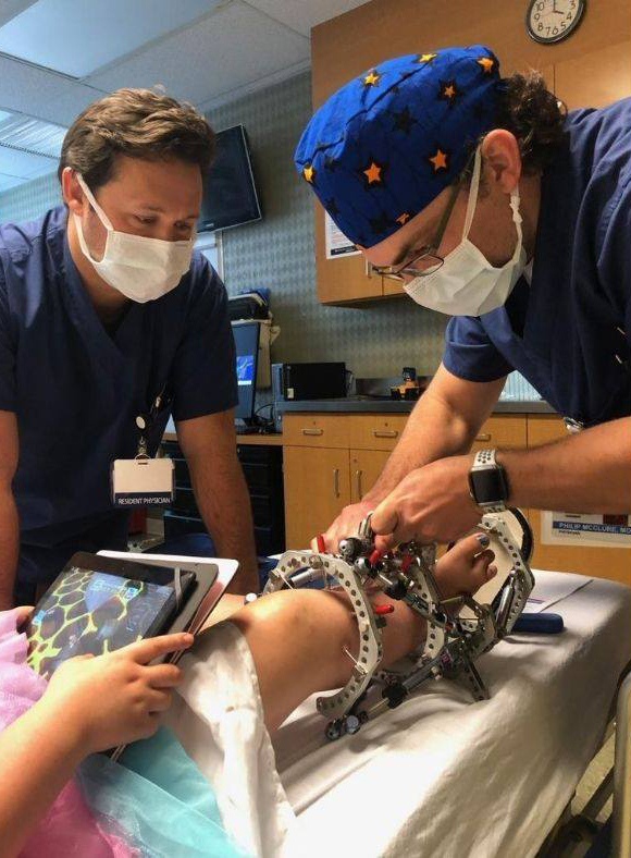 Dr. McClure adjusting the struts of a TL-HEX fixator for a child with fibular hemimelia