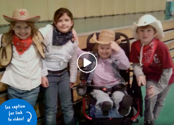 Girl in a wheelchair smiling with her friends