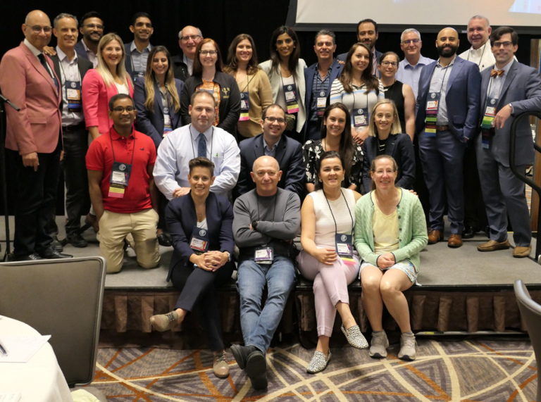 Photo of a group of former ICLL Fellows on the stage at the Baltimore Limb Deformity Course