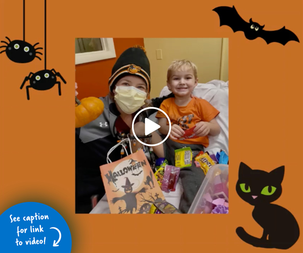 A young boy patient with an adult in PT enjoying a Halloween goody bag