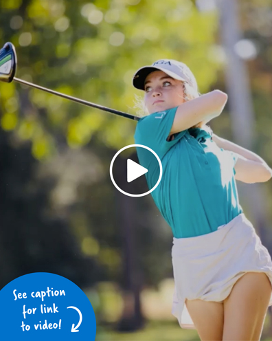 A young woman in the middle of a golf swing