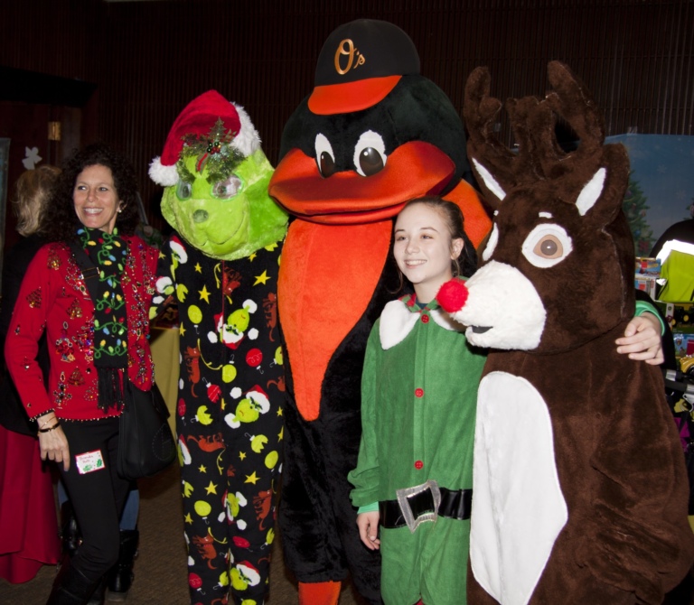 2 Volunteers, one dressed as elf, with Orioles mascot, Grinch character and Rudolph character