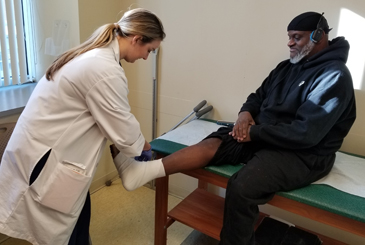 Andre having his ankle wrapped