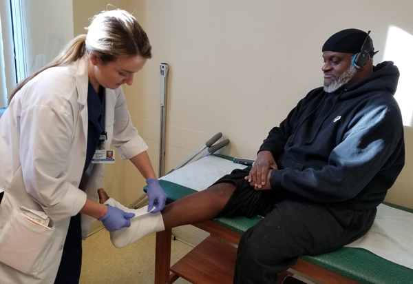 Andre having his ankle wrapped