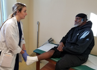 Andre having his ankle wrapped