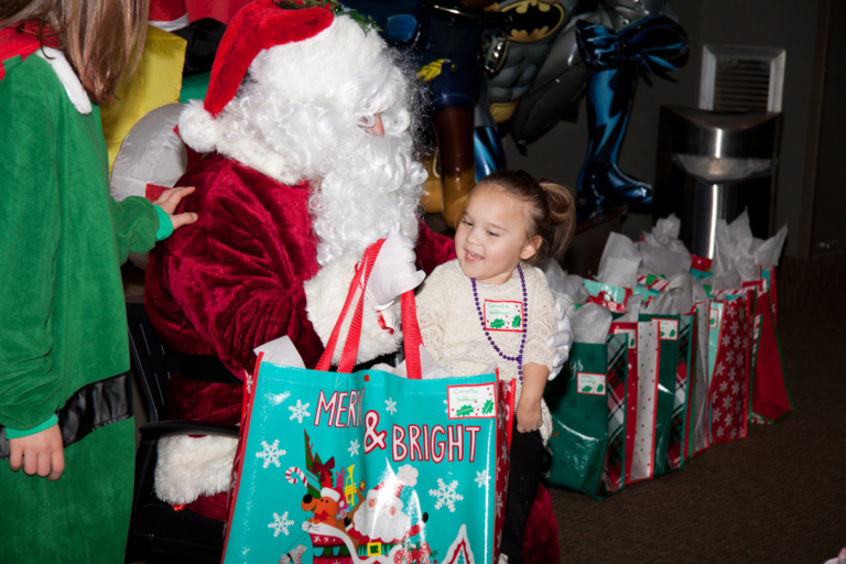 Santa gives present to young girl at the International Center for Limb Lengthening pediatric holiday party