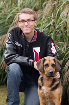 Chase in his varsity jacket with his dog