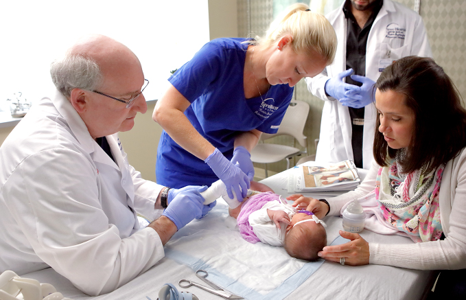 Dr. John Herzenberg casting a baby's legs who has clubfoot using the Ponseti Method at the International Center for Limb Lengthening