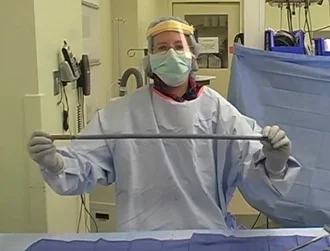 Dr. Janet Conway holding up the same nail coated in antibiotic cement