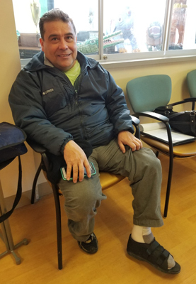 Julian, a patient of Dr. Christopher Bibbo, smiling after treatment for a broken ankle