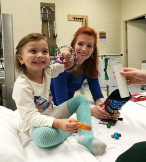 Anicka wearing an ex fix with her mother during physical therapy at the Rubin Institute