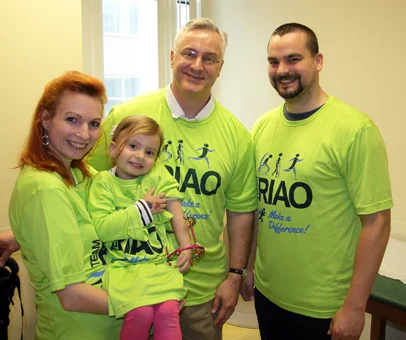 Anicka wearing an ex fix with her parents and Dr. Shawn Standard wearing Team RIAO (Rubin Institute for Advanced Orthopedics) T-shirts