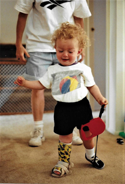 Christopher as toddler walking with cast