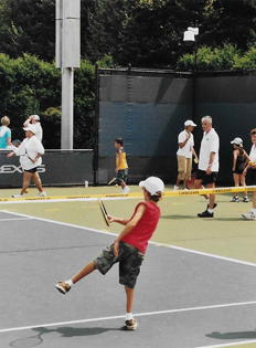 Christopher as a young boy playing tennis