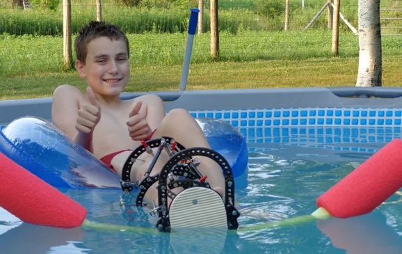 Chase in the pool with an external fixator from his first surgery at the International Center for Limb Lengthening