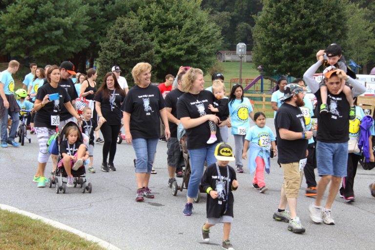 Multiple participants of all ages walking in the “Make a Difference Walk” at Rubin Institute for Advanced Orthopedics 2016 Save-A-Limb Fund Event