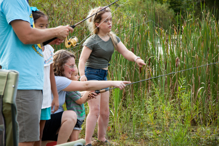 Patients and parents fishing at pond during Rubin Institute for Advanced Orthopedics 2018 Save-A-Limb Pool Party event