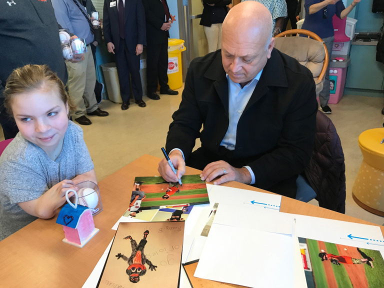 Cal Ripken autographs photo for girl patient at Cal Ripken at Herman & Walter Samuelson Children