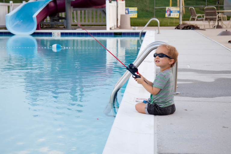 Young boy fishing in swimming pool at Rubin Institute for Advanced Orthopedics 2018 Save-A-Limb Pool Party event