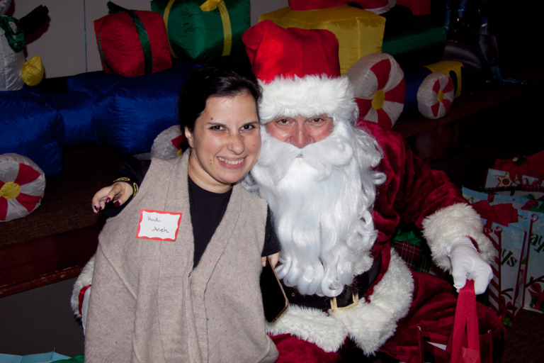 Santa and young woman patient at the International Center for Limb Lengthening pediatric holiday party