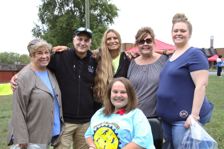 Pediatric Liaison Marilyn Richardson and Dr. Shawn Standard pose for a picture with girl in wheelchair and 3 women at Rubin Institute for Advanced Orthopedics 2016 Save-A-Limb Fund Event