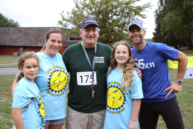 Dr. John Herzenberg posing for a photo with 2 young girls, woman, and man at Rubin Institute for Advanced Orthopedics 2016 Save-A-Limb Fund Event