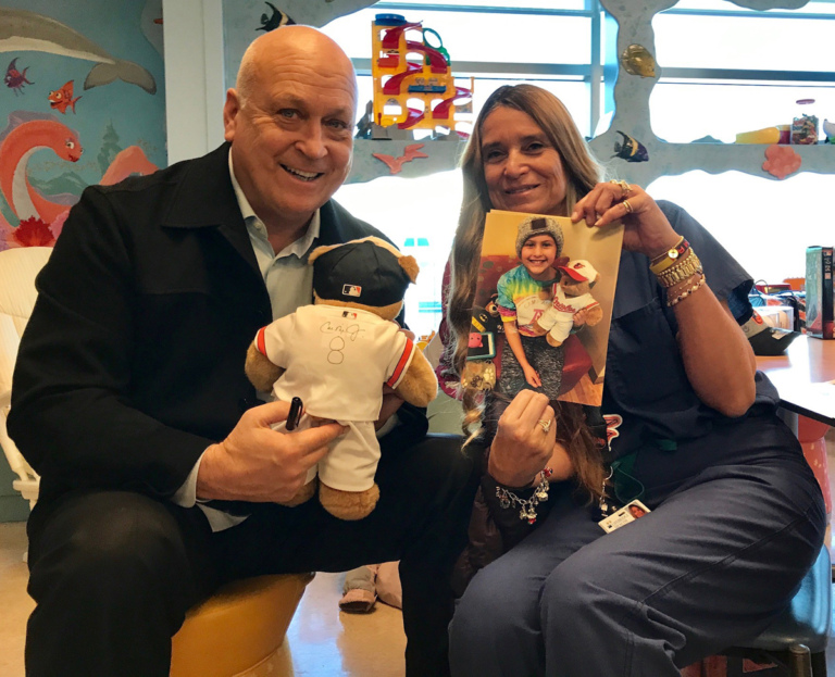 Marilyn Richardson, Pediatric Liaison and Cal Ripken pose for picture while holding autographed Baltimore Orioles teddy bear and patient picture at Herman & Walter Samuelson Children