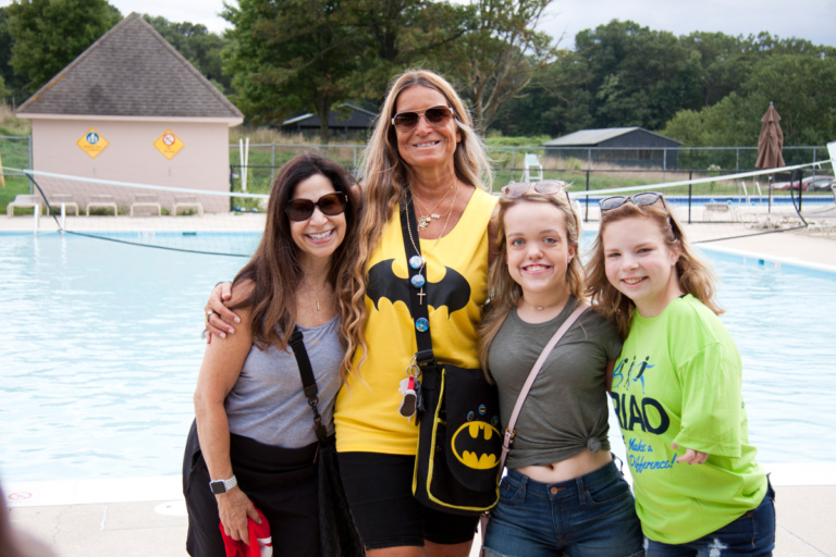 Marilyn Richardson, Pediatric Liaison, Merrill Herzenberg, and 2 female patients pose for photo at Rubin Institute for Advanced Orthopedics 2018 Save-A-Limb Pool Party event