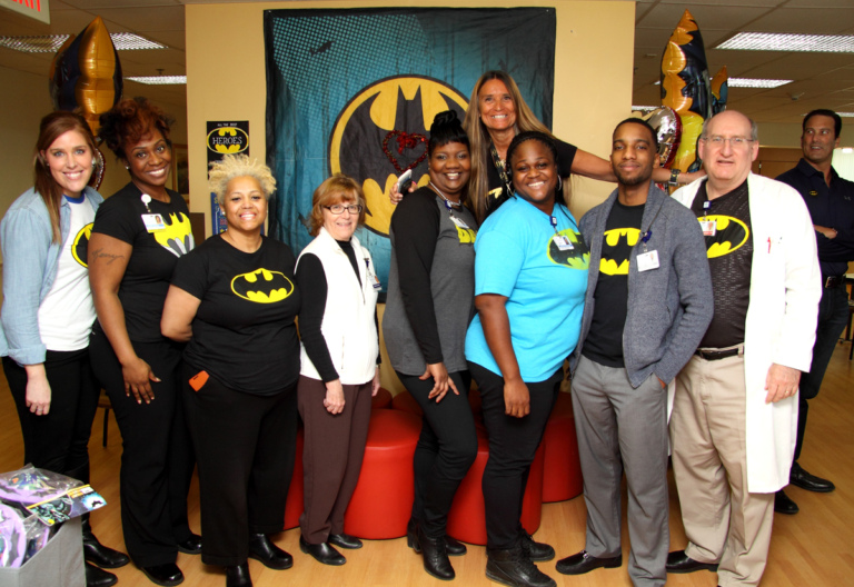 Dr. John Herzenberg and 8 staff members of the International Center for Limb Lengthening show off their Batman shirts at the International Center for Limb Lengthening’s Leonard B. “Batman” Robinson Memorial Valentine’s Day Party