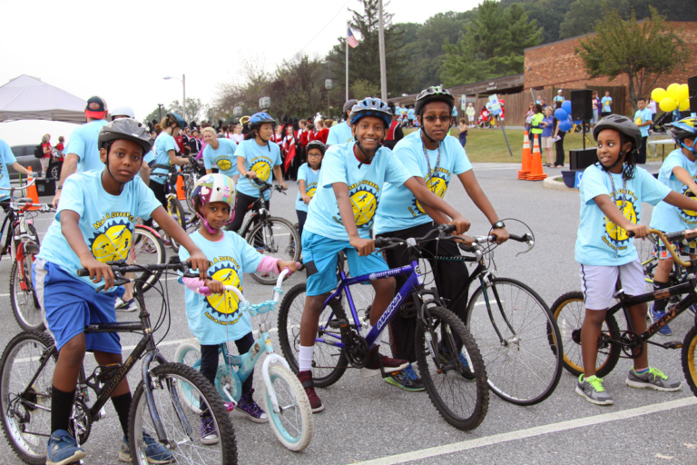 5 children in Save-A-Limb blue event shirts on bikes at Rubin Institute for Advanced Orthopedics 2016 Save-A-Limb Fund Event