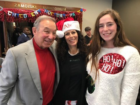 Rubin Institute for Advanced Orthopedics Chairman Dr. Jerome Reichmister with two female volunteers at the International Center for Limb Lengthening pediatric holiday party