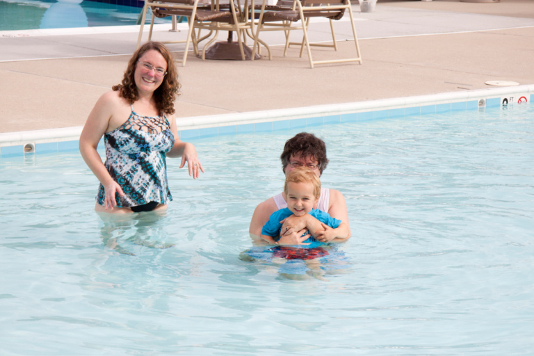 Toddler boy with mother and father in pool at Rubin Institute for Advanced Orthopedics 2018 Save-A-Limb Pool Party event