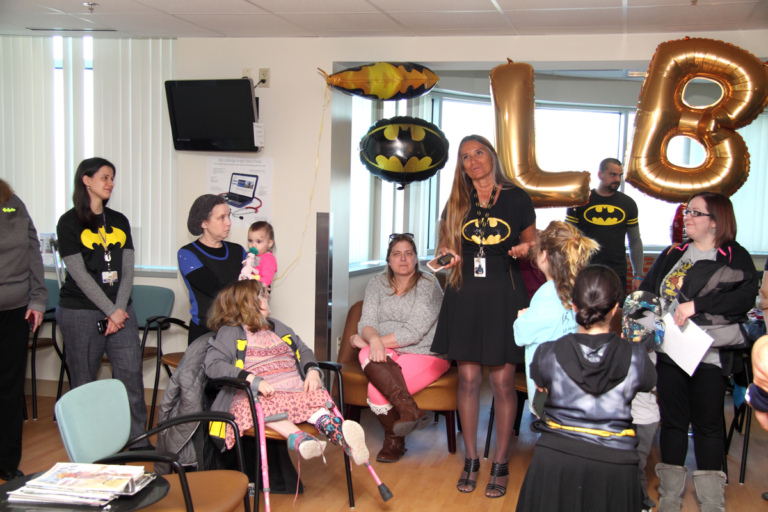 Pediatric Liaison Marilyn Richardson in Batman dress speaks to the families, patients and staff at the International Center for Limb Lengthening’s Leonard B. “Batman” Robinson Memorial Valentine’s Day Party