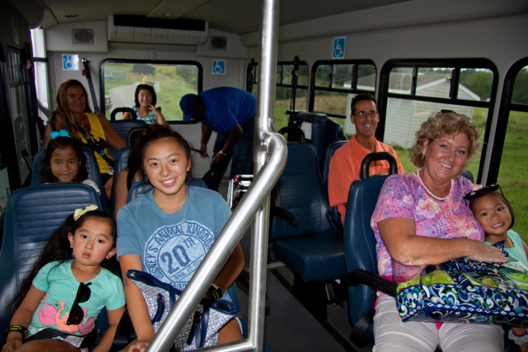 Mother, father and five girls ride shuttle bus with Pediatric Liaison Marilyn Richardson at Rubin Institute for Advanced Orthopedics 2018 Save-A-Limb Pool Party event