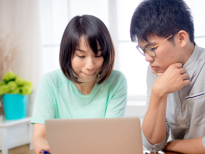 Man and woman chatting online with a doctor