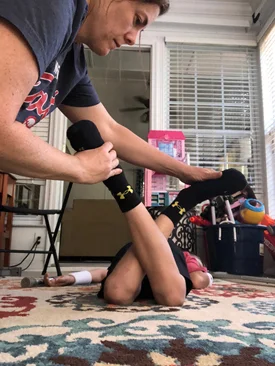 Patient doing home physical therapy leg cross exercises