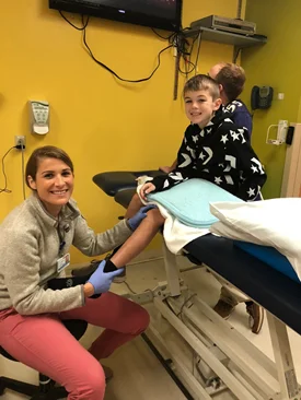 Patient and physical therapist smiling during a physical therapy session at the Rubin Institute for Advanced Orthopedics