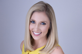 Carly’s professional photograph with her standing in a yellow dress