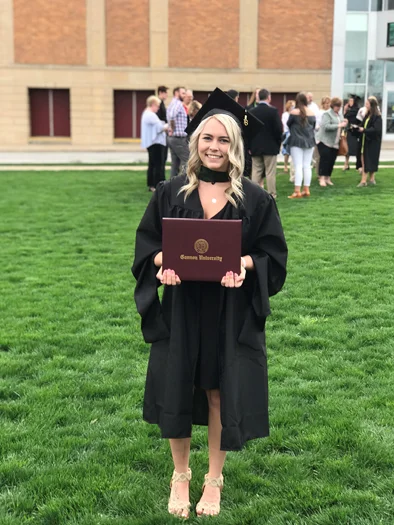 Emily in cap and gown at her graduation