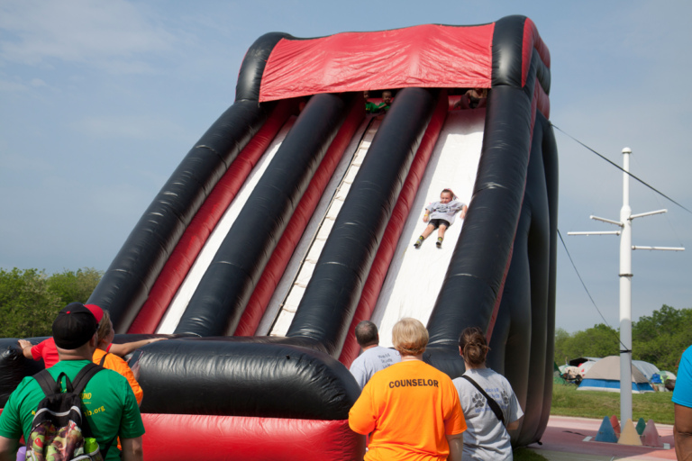 Giant inflatable slide with one child sliding down