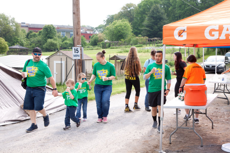 A family of 4 at the walk passing a Gatorade stand