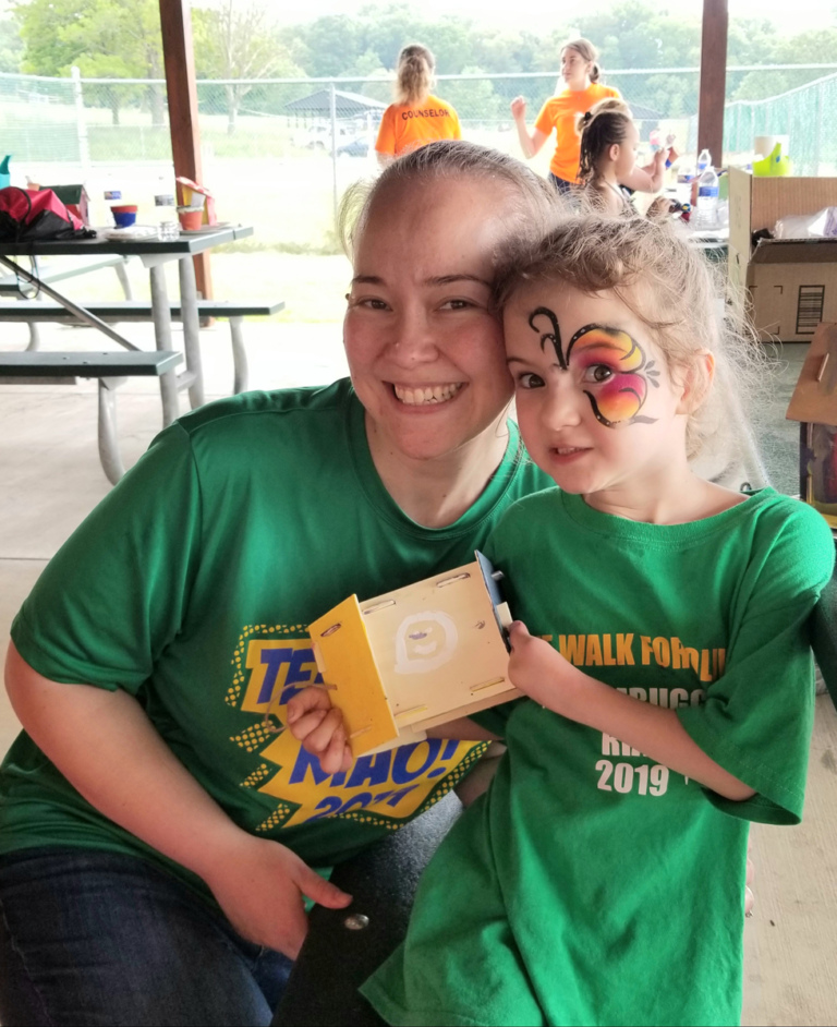 A mother and young daughter patient showing off the birdhouse she painted