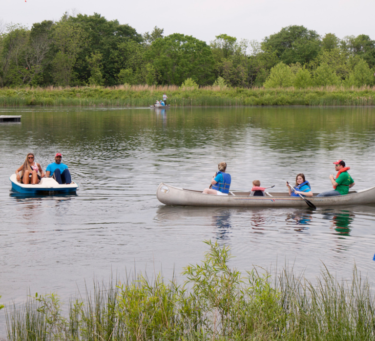 Staff and participants paddle boating and canoeing