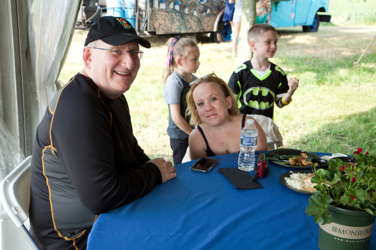 Dr. John Herzenberg sitting with a patient at the dinner