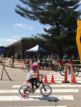 Charlotte riding her bike with a shoe lift