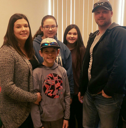 Jackson with his family at a post-treatment follow-up clinic visit