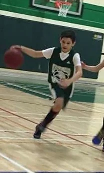 Jackson running while dribbling a basketball on the court post-treatment