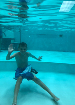 Preston wearing an external fixator while playing around underwater in the hydrotherapy pool