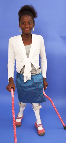 Melissa standing with leg braces and canes