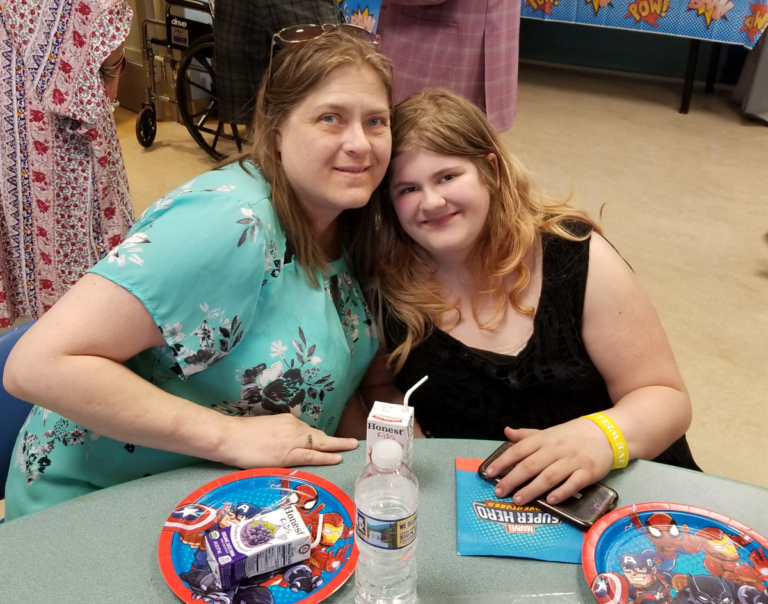 Girl patient and her mother enjoying lunch